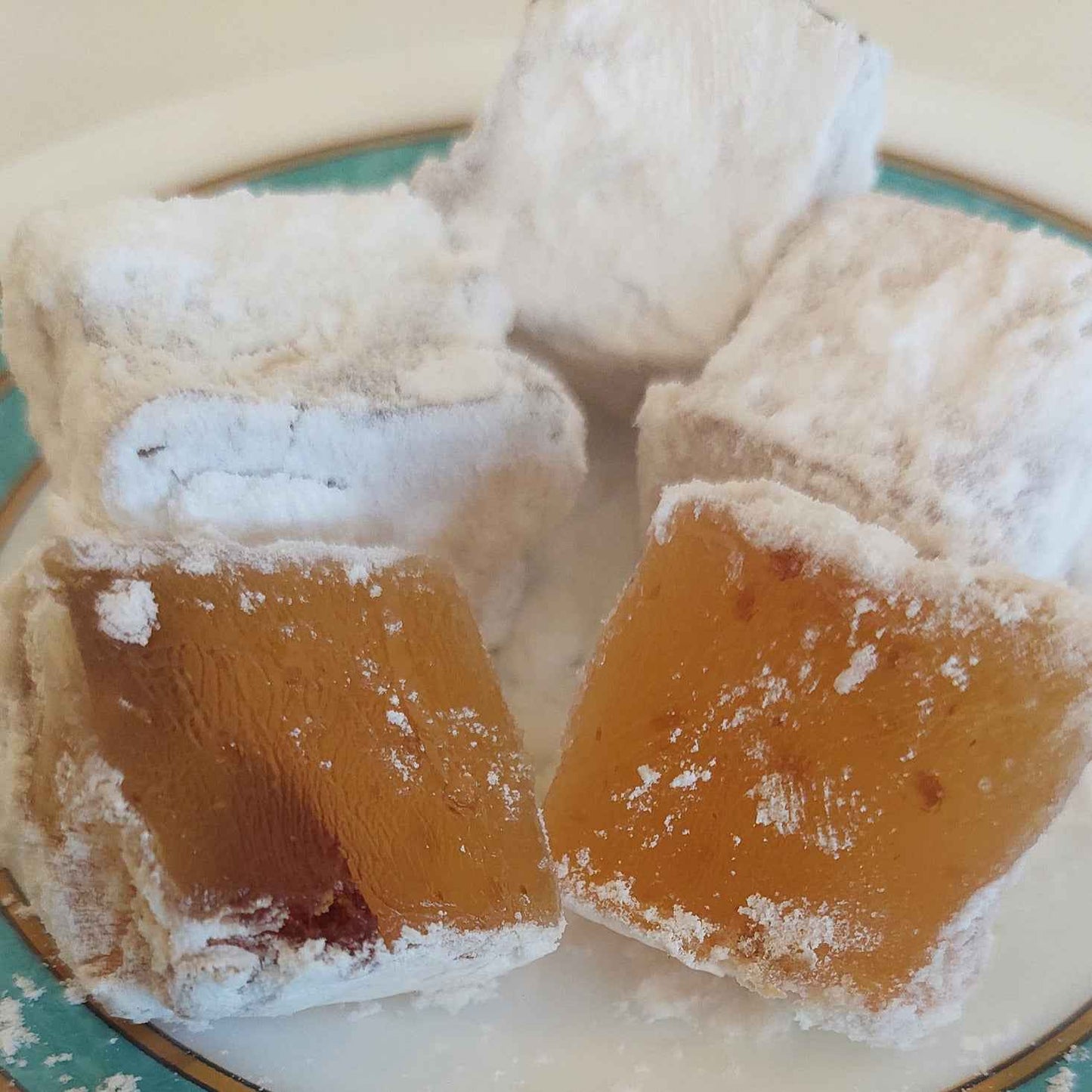 Close-up of soft Greek almond loukoumi with powdered sugar