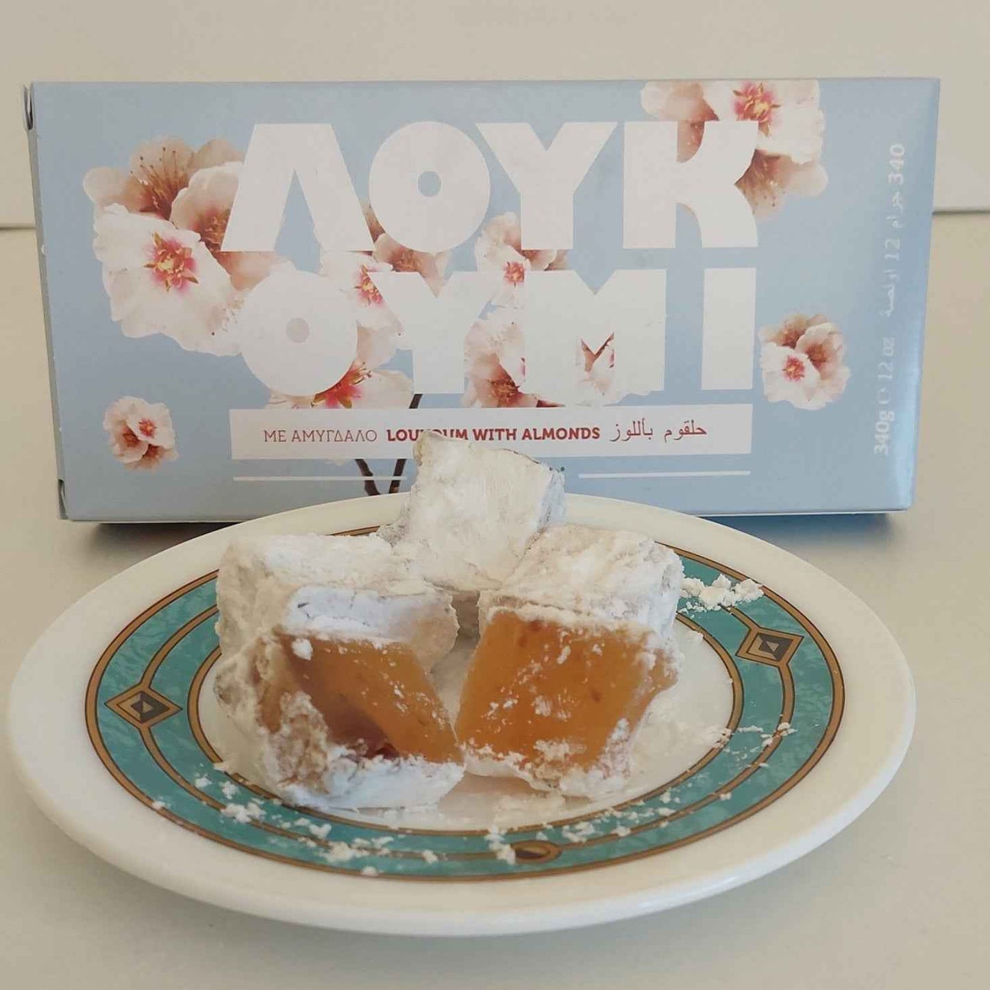Traditional Greek almond loukoumi served beside its gift box